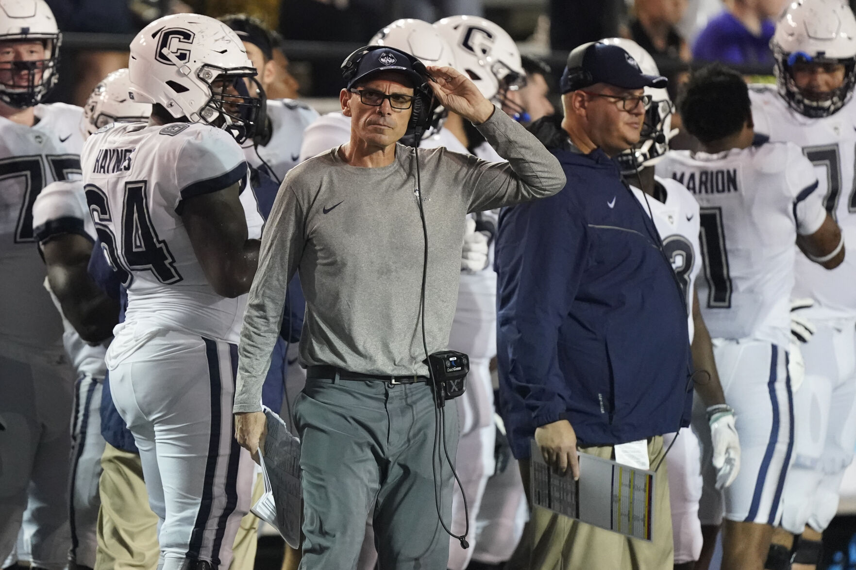 UConn football coach on sidelines